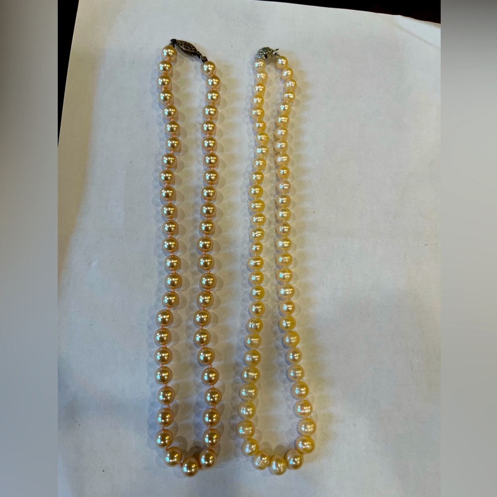 Two pink pearl necklaces. 1 genuine and one high quality glass
